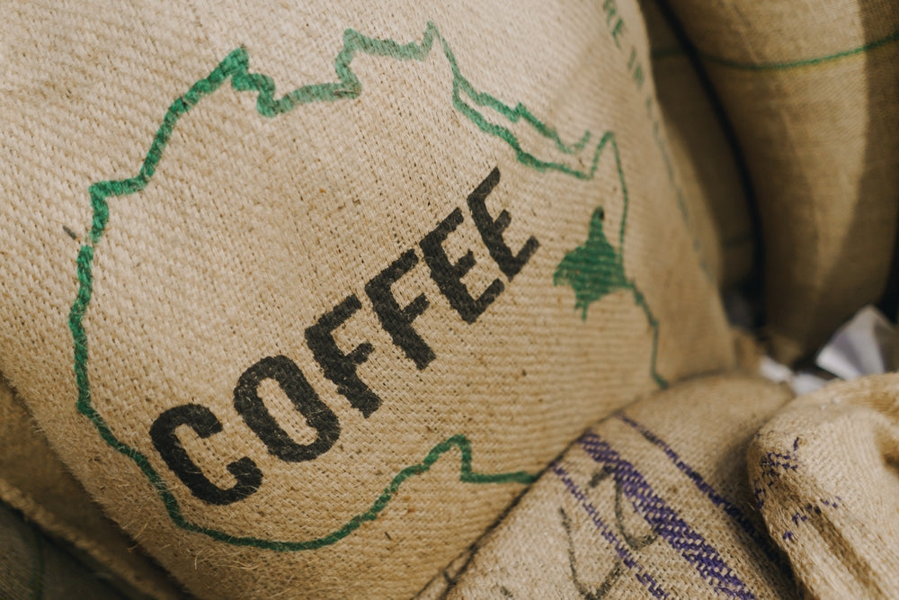 Jute bags of green coffee beans imported from Kenya.