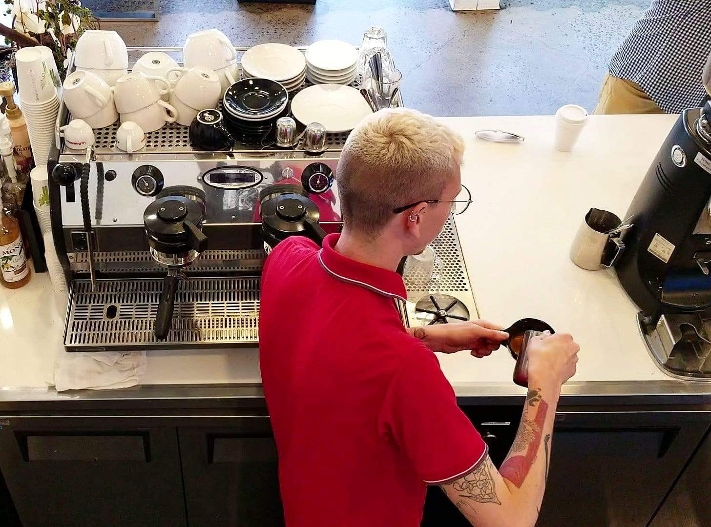 weaverscoffee.sbs Barista in red shirt makes Espresso Coffee drink.