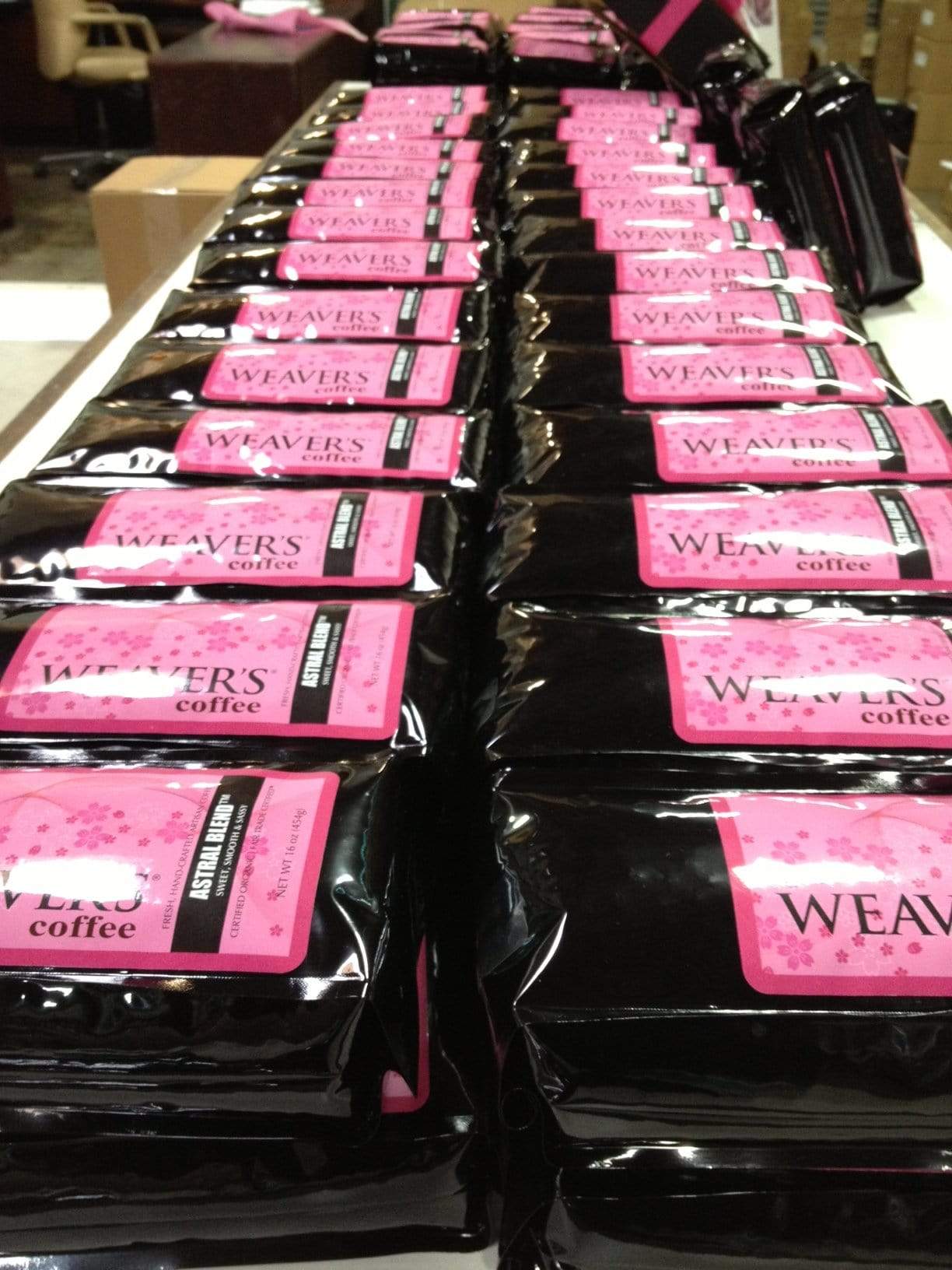 weaverscoffee.sbs Dozens of Coffee bags of Astral Blend Coffee lined up in a row.